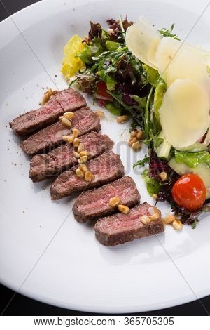 Grilled Roast Beef Salad Served With Arugula And Parmesan Cheese