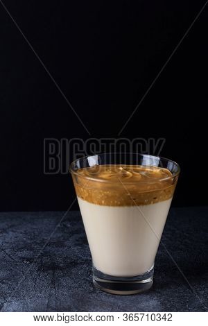 Dalgon Coffee In A Glass Against A Dark Background.