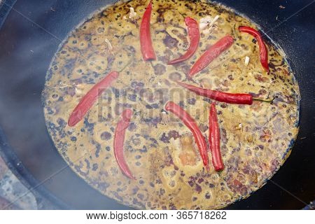 National Uzbek Dish Pilaf, Pilaw, Plov, Rice With Meat In Big Pan. Cooking Process In A Cauldron On 