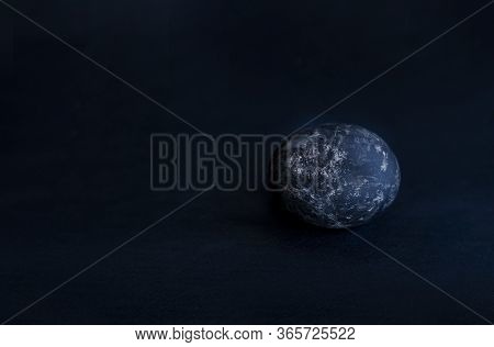 On A Black Background An Egg Of Black Color Asymmetrically Placed Egg
