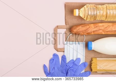 Safe Food Delivery. Midical Mask And Gloves, Bottles Of Oil And Milk, Spaghetti, Baguette On The Lig