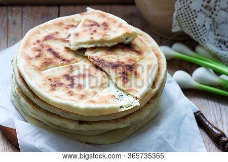 Traditional In Different Countries Pies Stuffed With Cheese And Herbs, Fresh Garlic And Wine On A Wo