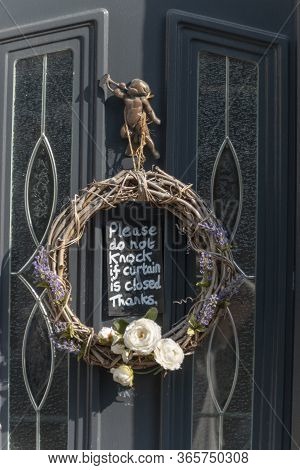 Bristol-may-2020-england- A Close Up View Of A Front Door With A Natureal Reeth And A Warning Sign I