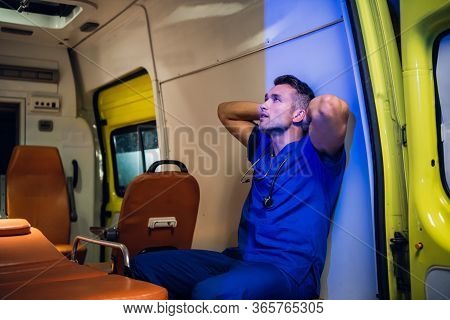 Corpsman Having A Little Rest, Sitting In An Ambulance Car