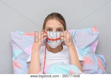 Girl Shows A Smile On Her Face Made Of Threads, Doing Knitting At Home In Self-isolation Mode