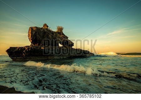 Amazing Seascape. Sunrise At Yeh Gangga Beach. Rock In The Ocean. Natural Hole In Rock Formation. Wa