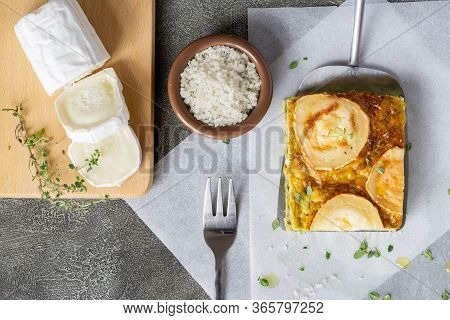 Zucchini Pie Or Quiche With Goat Cheese On Wooden Cutting Board. Slice Of Goat Cheese Near It. Healt