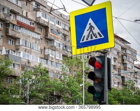 Red Traffic Light With Worn Out Apartment Building From Communist Era In The Background