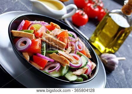 Close-up On A Black Plate Of Canned Tuna And Green Bean Salad With Lemon Dressing And Vegetables: To