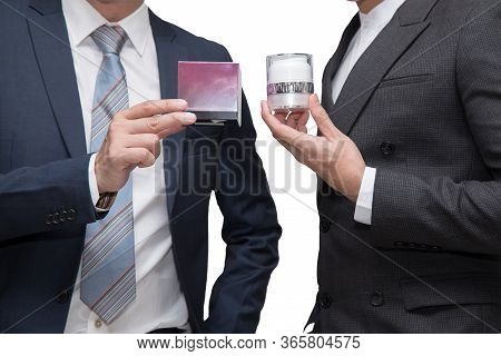Two Businessmen Holding Beauty Product Together On White Background
