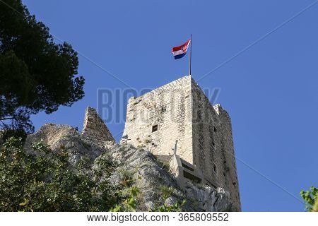 Flag Blows Over Tower Of Old Fortress In Croatia