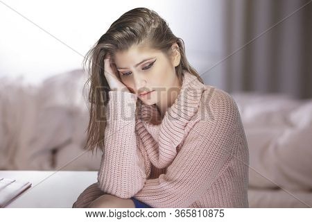 Lonely Woman At Home During A Pandemic Lockdown Or Quarantine Feeling Despair And Sadness Because Of