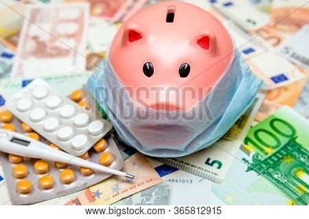 Piggy Bank In A Mask On A Background Of European Currency.the Concept Of Coronavrius Epidemic