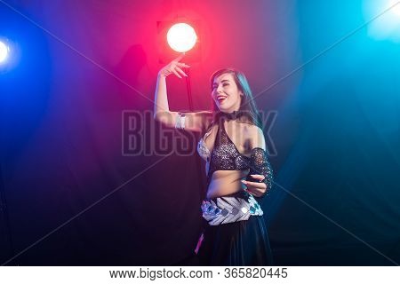 Girl Dancing Belly Dance, Fusion Or Tribal. A Woman In A Beautiful Costume Demonstrates Charming And