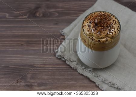 Dalgona Coffee On A Wooden Background With Copy Space. Homemade Dalgona Coffee In Glass With Milk. T