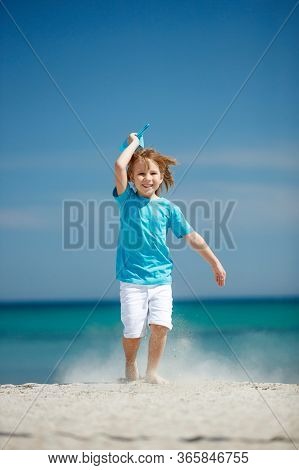 Child Boy Plays At Sea With An Airplane. Dream To Travel.
