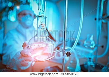 COVID-19 or SARS-CoV-2. Doctor, microbiologist, scientist in a protective suit, makes a study of coronavirus in the laboratory. Coronavirus test.