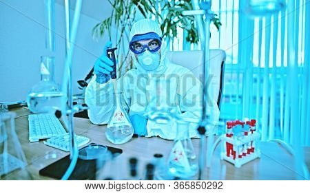 COVID-19 or SARS-CoV-2. Doctor, microbiologist, scientist in a protective suit, makes a study of coronavirus in the laboratory. Coronavirus test.