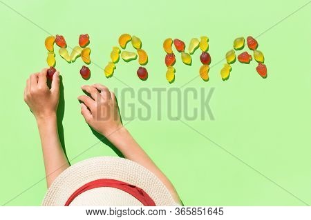 Childs Hands Making Word Mama With Jelly Candies