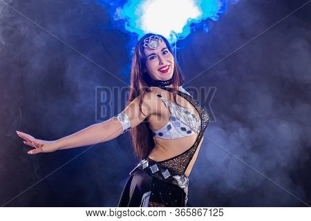 Girl Dancing Belly Dance, Fusion Or Tribal. A Woman In A Beautiful Costume Demonstrates Charming And