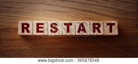 Wooden Blocks With The Text: Restart. New Business Relaunch Startup Concept
