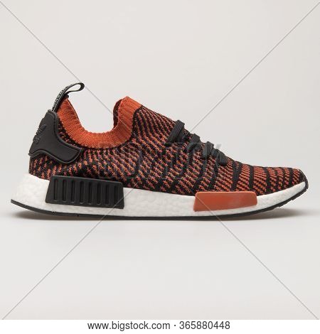 Vienna, Austria - August 13, 2018: Adidas Nmd R1 Black And Orange Sneaker On White Background.