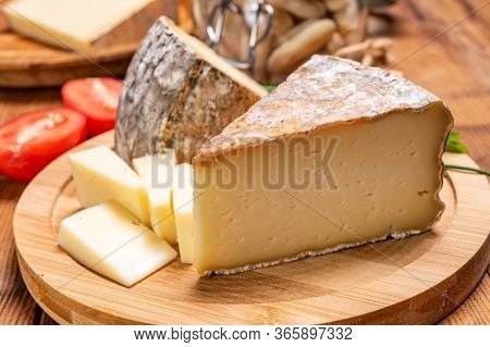Pieces Of Cheese Tomme De Montagne Or Tomme De Savoie Made From Cow Milk In French Alps.