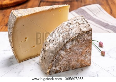 Pieces Of Cheese Tomme De Montagne Or Tomme De Savoie Made From Cow Milk In French Alps.