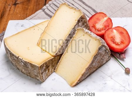 Pieces Of Cheese Tomme De Montagne Or Tomme De Savoie Made From Cow Milk In French Alps.