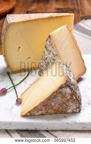 Pieces Of Cheese Tomme De Montagne Or Tomme De Savoie Made From Cow Milk In French Alps.
