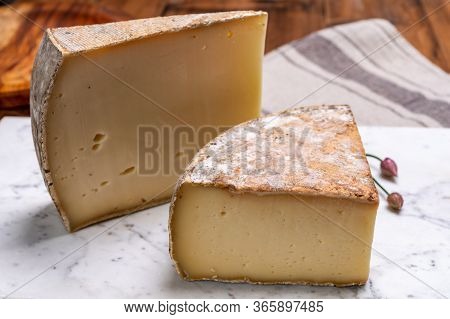 Pieces Of Cheese Tomme De Montagne Or Tomme De Savoie Made From Cow Milk In French Alps.