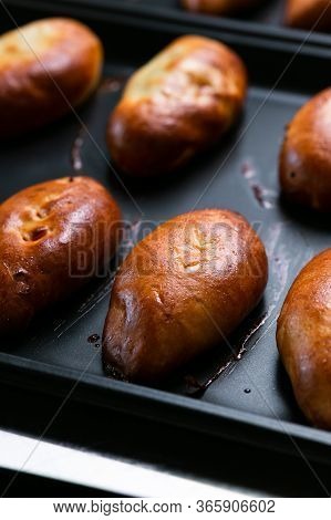 Ready Golden Pies On Pan Sheet. Arranged Stuffed Pies With Golden Crust On Metal Sheet.