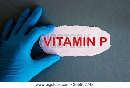 Hand In Blue Glove With White Small Paper. Concept Word Vitamin P.