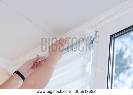 Man Hands Installing Window Roller Duo System Day And Night.