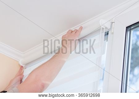 Man Hands Installing Window Roller Duo System Day And Night.