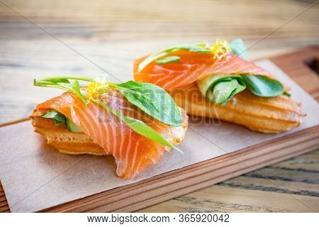 Salty Ecler With Fresh Salmon On Top And Cheese
