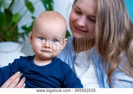 Happy Baby. Little Cutest Chubby Caucasian White Infant Child Looking And Smiling At Camera On Mothe