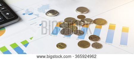 Colorful Sales Charts, Calculator, Blue Pen And Glasses. Shallow Dof, Focus On Charts