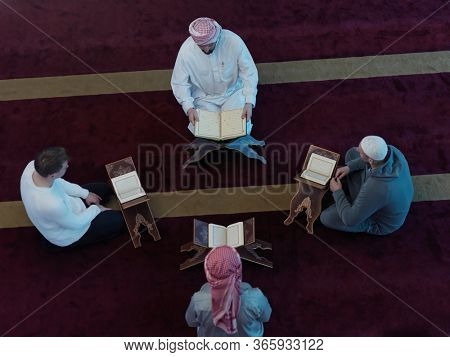 top view of muslim people in mosque reading quran together concept of islamic education and school of holly book kuran