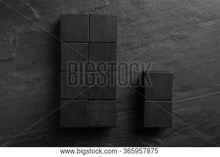 Flat Lay Composition With Cubes On Black Slate Background. Pareto Principle Concept