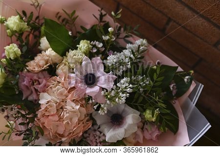 Fresh Flowers Bouquet On Shelf In Front Of Brick Wall