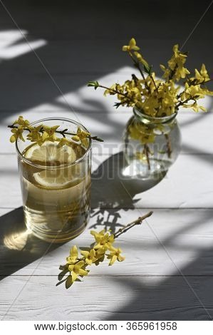 Fresh Lemonade With Yellow Flowers On The Table.