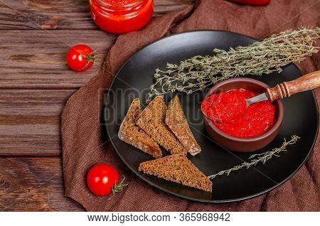 Ajvar Or Pindjur Red Vegetable Spread Or Pepper Paprika And Tomato Mousse In A Clay Bowl In A Black 