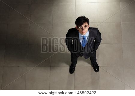 Image of young businessman in glasses. Top view