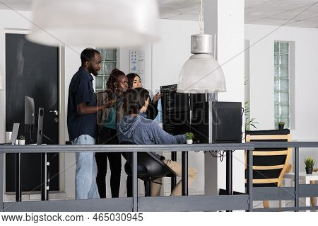 Diverse Team Of Web Developer Analyzing Html Code On Terminal Window, Working With Script And Artifi