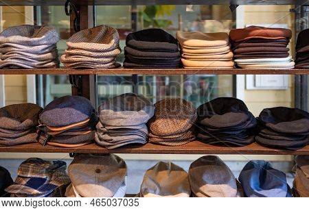 Varieties Of Caps And Hats For Men On The Shelf Of A Clothing Shop. Peaky Blinders Style Hats. 1920s