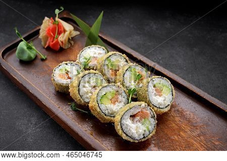 Sushi Roll Banzai On A Wooden Board, On Dark Concrete