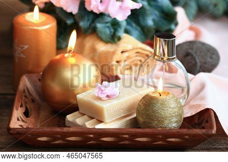 Spa Concept With Candles In Gold And Pink. Handmade Olive Soap, Facecloth, Towel, Candles And Pink C