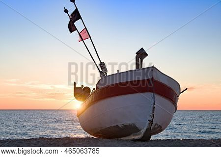 Fishing Boat On The Beach Of The Polish Baltic Coast Near Rewal. Sunset