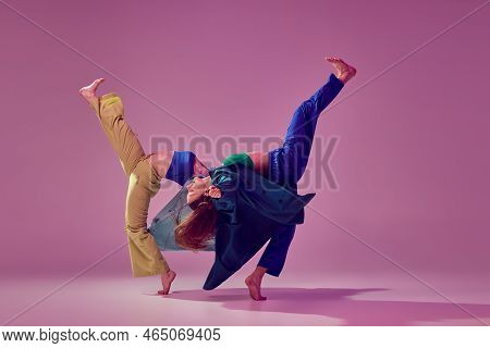 Contemporary Dance Couple In Motion And Action Isoltaed On Crystal Pink Background. Young Stylish Fa